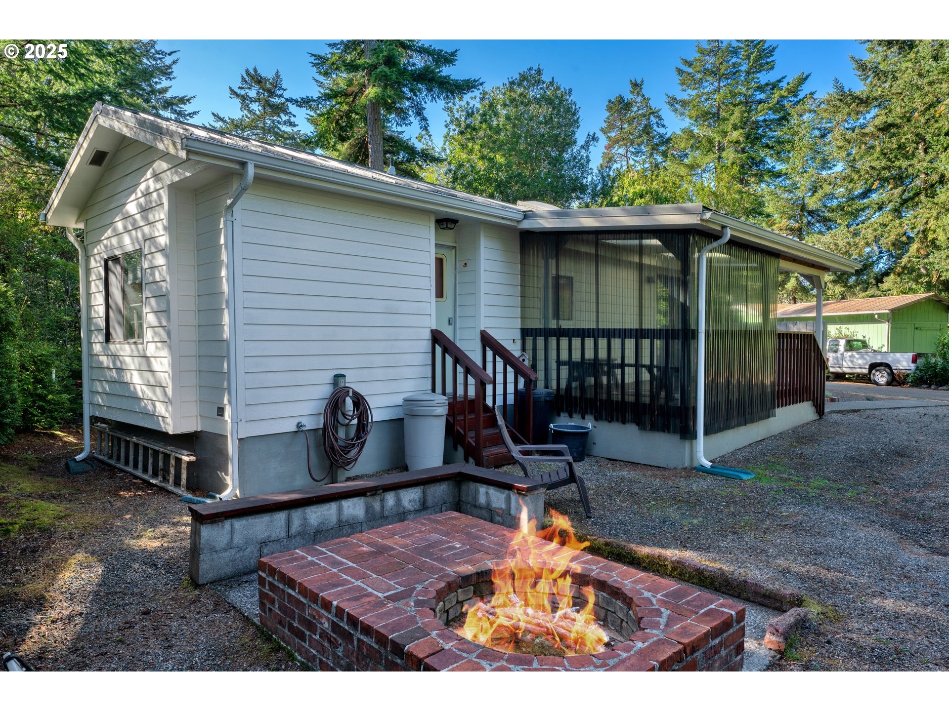 225 Azalea Street Florence, OR 97439 - Photo 2 of 15 a backyard of a house with table and chairs