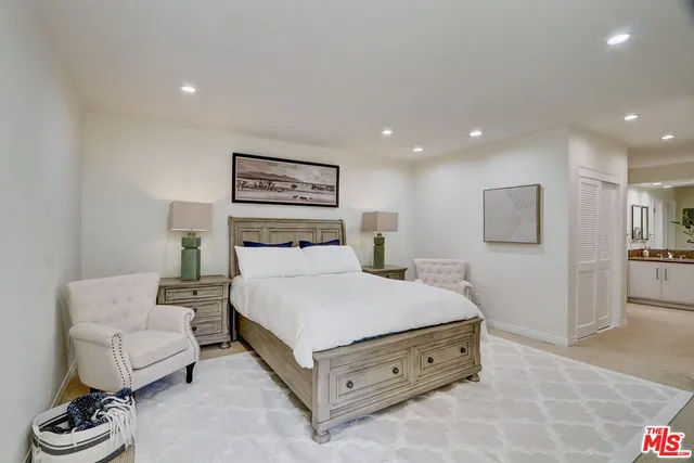 a spacious bedroom with a bed and a couch