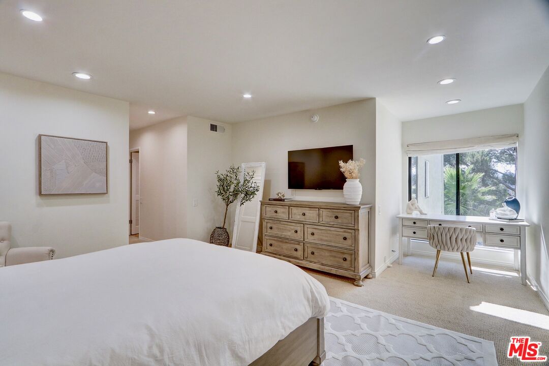 2345 Roscomare Road, Unit 303 Los Angeles, CA 90077 - Photo 13 of 23 a bedroom with a bed and a flat screen tv in the kitchen