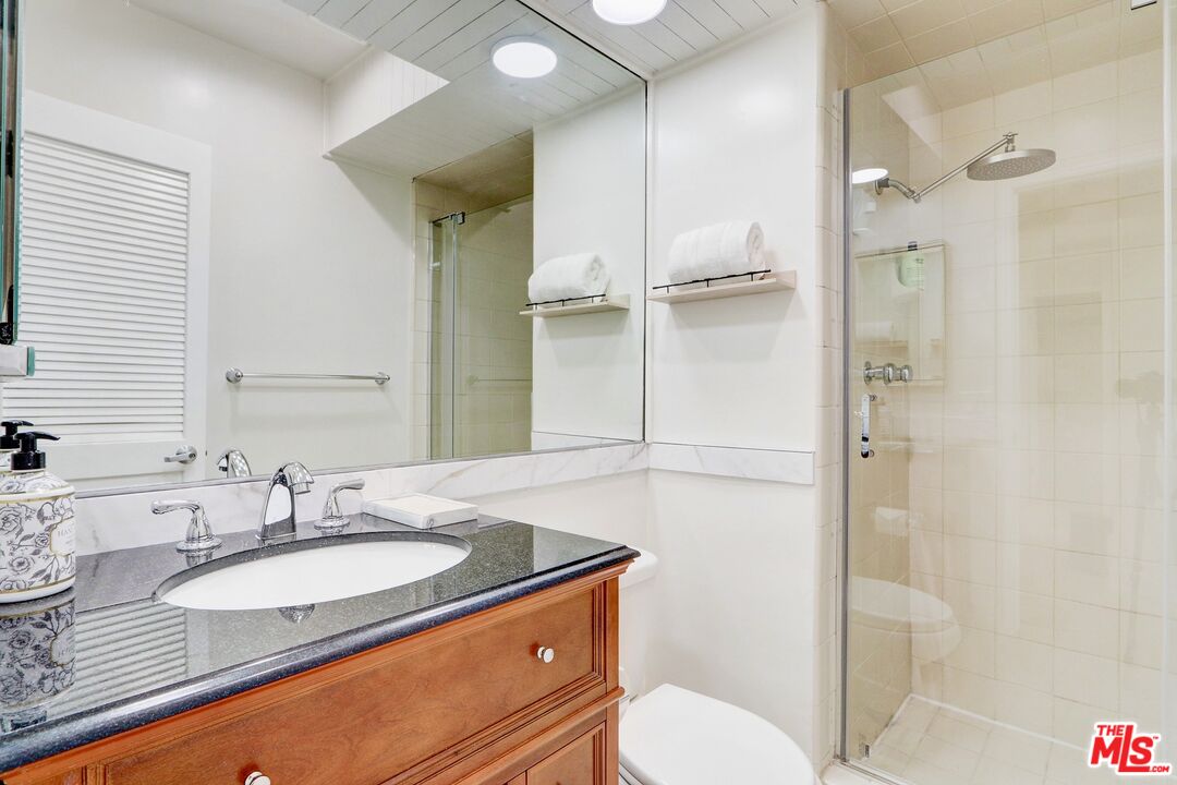 2345 Roscomare Road, Unit 303 Los Angeles, CA 90077 - Photo 16 of 23 a bathroom with a granite countertop sink toilet and shower
