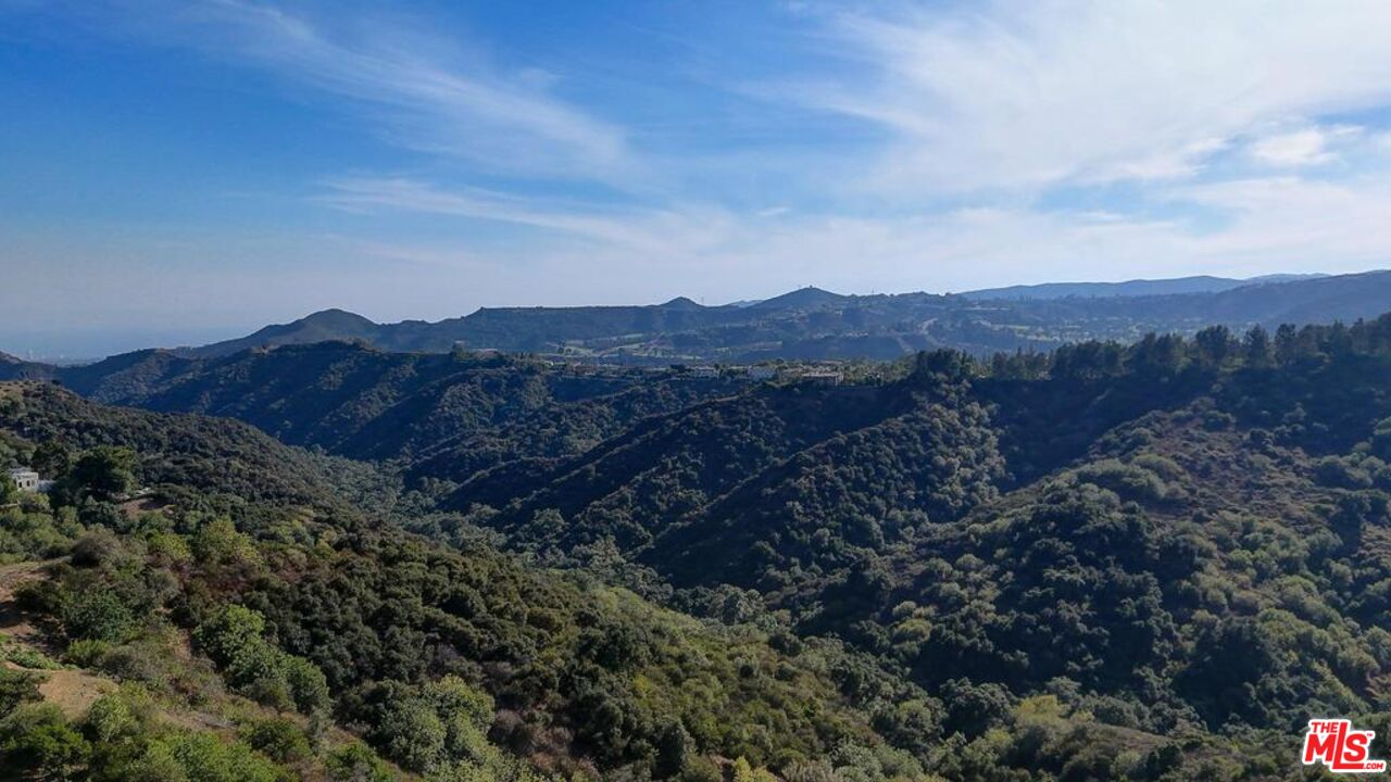 2345 Roscomare Road, Unit 303 Los Angeles, CA 90077 - Photo 17 of 23 a view of a house with a mountain in the background