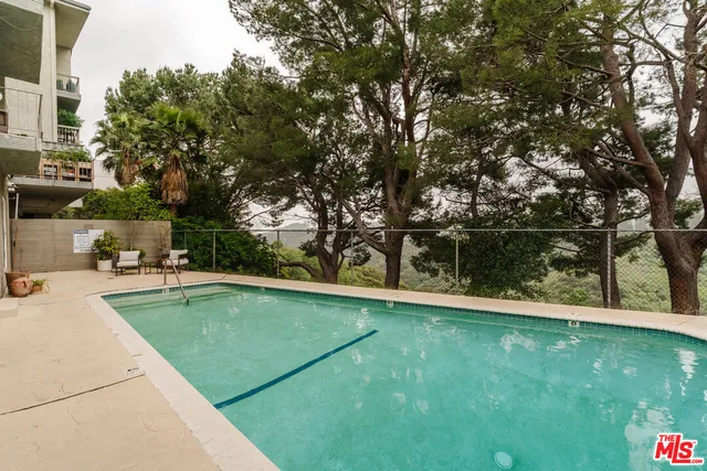 a view of a swimming pool with a yard