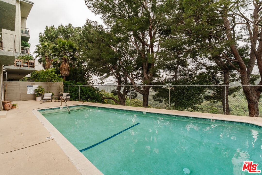 2345 Roscomare Road, Unit 303 Los Angeles, CA 90077 - Photo 19 of 23 a view of a swimming pool with a yard