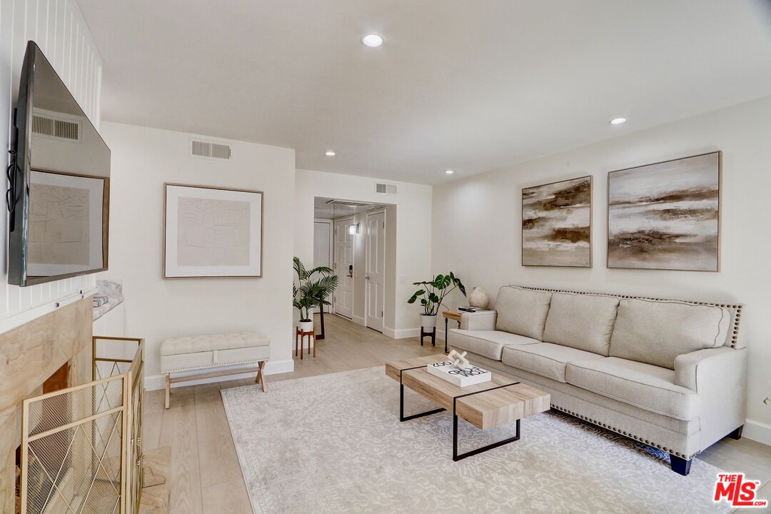 2345 Roscomare Road, Unit 303 Los Angeles, CA 90077 - Photo 3 of 23 a living room with furniture and a flat screen tv