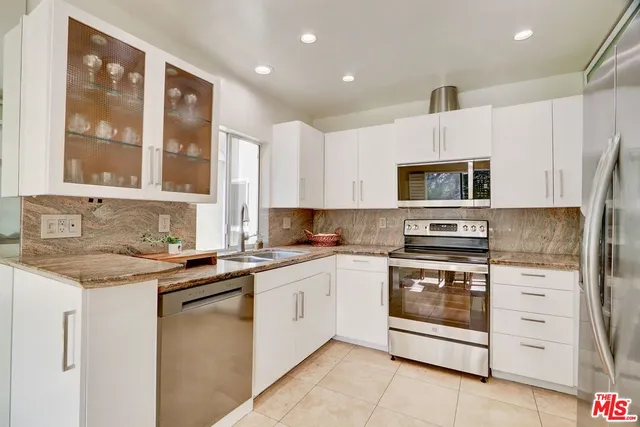 a kitchen with a sink stove and microwave