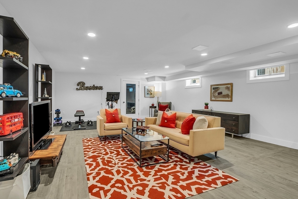38 Downing Road Lexington, MA 02421 - Photo 28 of 41 a living room with furniture and a flat screen tv