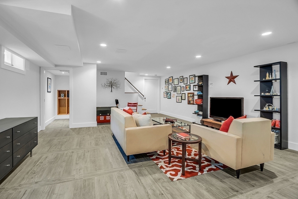 38 Downing Road Lexington, MA 02421 - Photo 29 of 41 a living room with furniture and a flat screen tv