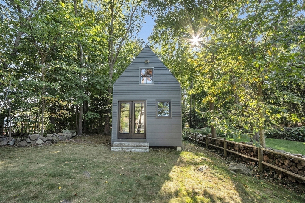 38 Downing Road Lexington, MA 02421 - Photo 35 of 41 a house with trees in front of it