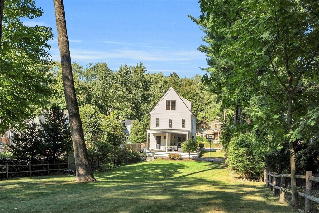 38 Downing Road Lexington, MA 02421 - Photo 40 of 41 a front view of a house with a yard table and chairs