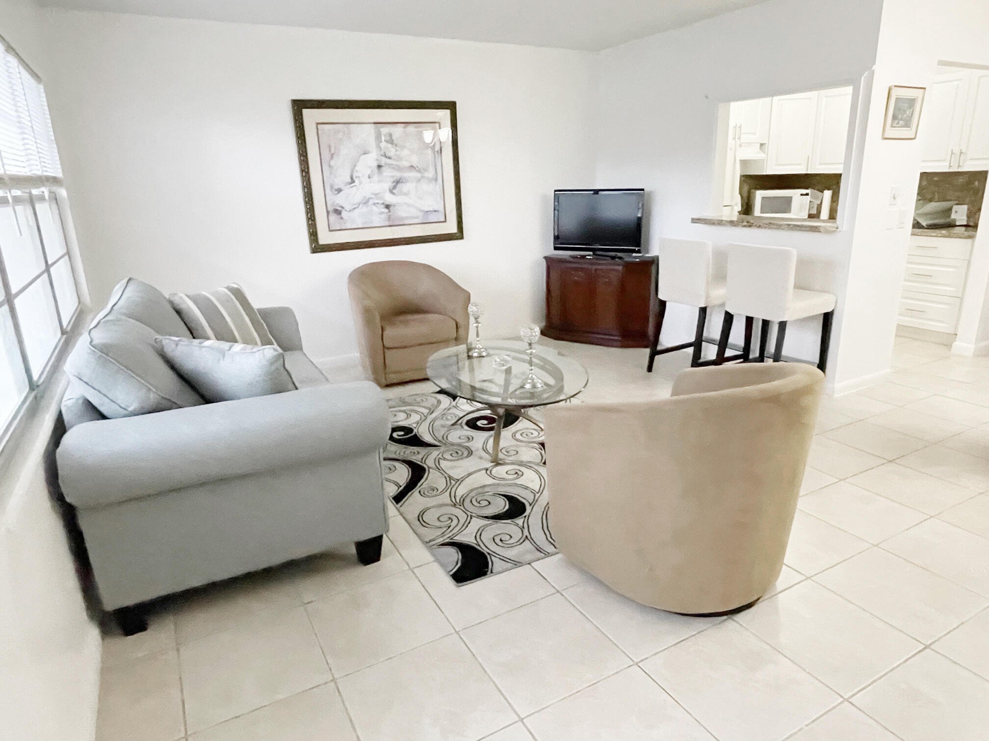 171 Suffolk F, Unit 171 Boca Raton, FL 33434 - Photo 7 of 21 a living room with couches and a flat screen tv