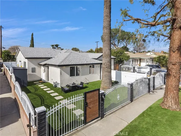 a view of a house with wooden fence