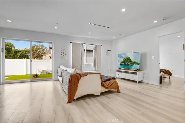 a spacious bedroom with a bed and a couch