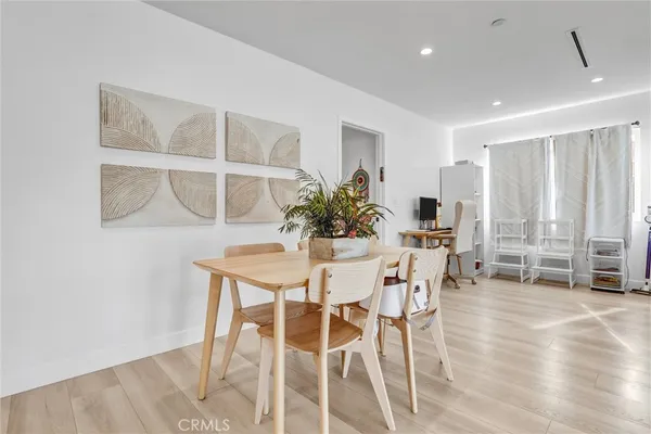 a dining room with furniture and wooden floor