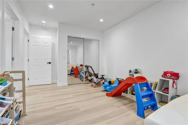 a bedroom with furniture and a wooden floor