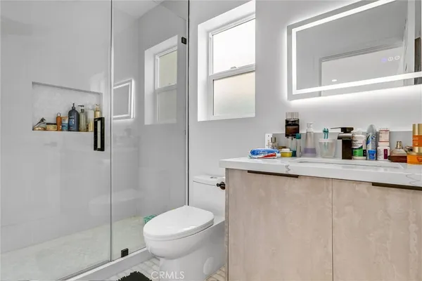 a bedroom with furniture and a wooden floor