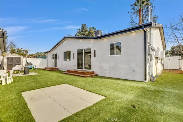 a building view with swimming pool and red umbrella