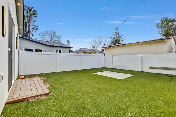 a kitchen with stainless steel appliances a white wooden cabinets and white walls