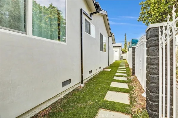 a large kitchen with a sink and refrigerator