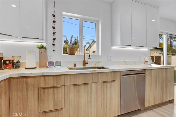a kitchen with stainless steel appliances a sink and cabinets