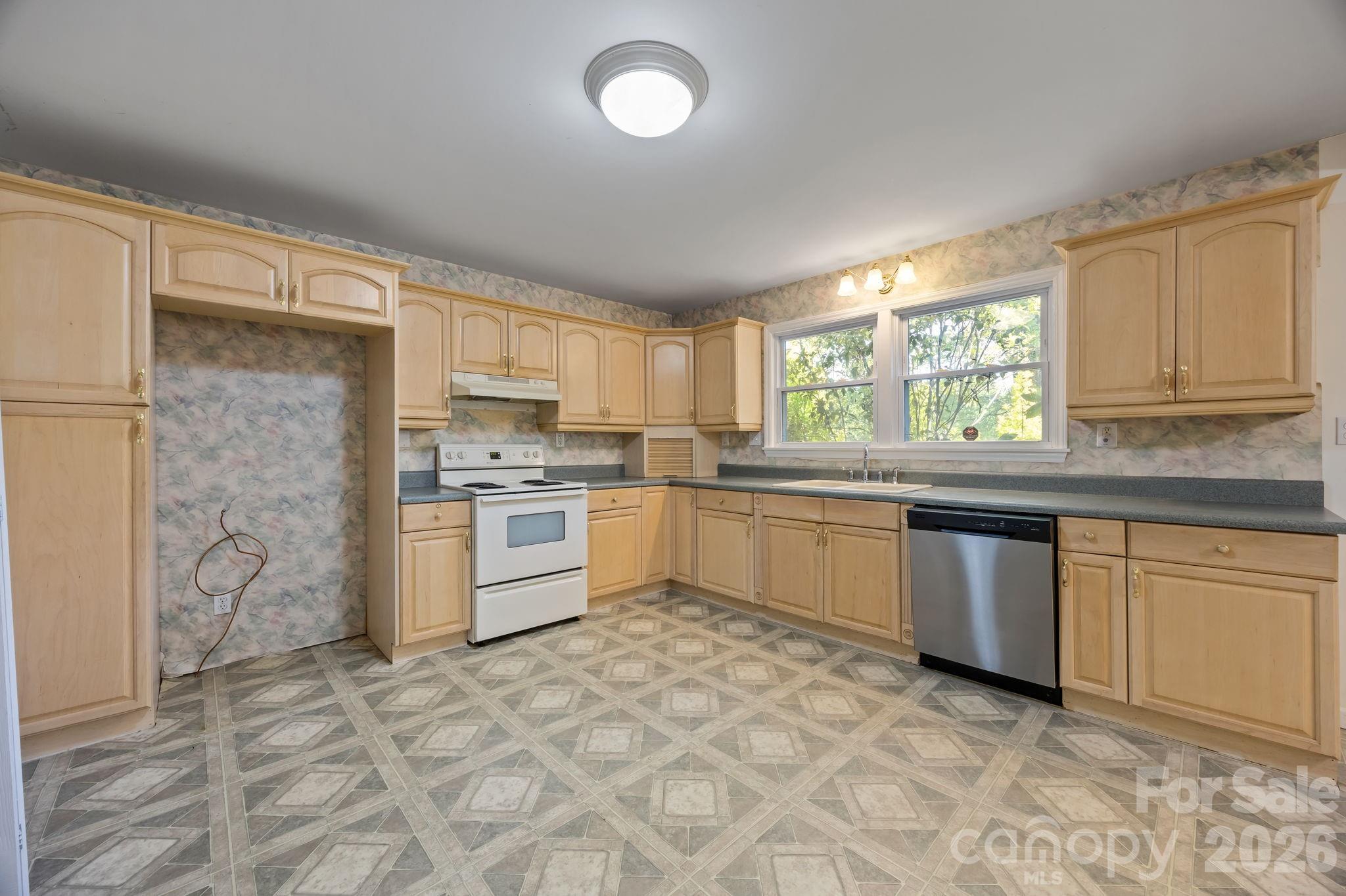 1311 Jenkins Road Gastonia, NC 28052 - Photo 22 of 47 a kitchen with granite countertop a sink cabinets stainless steel appliances and a window