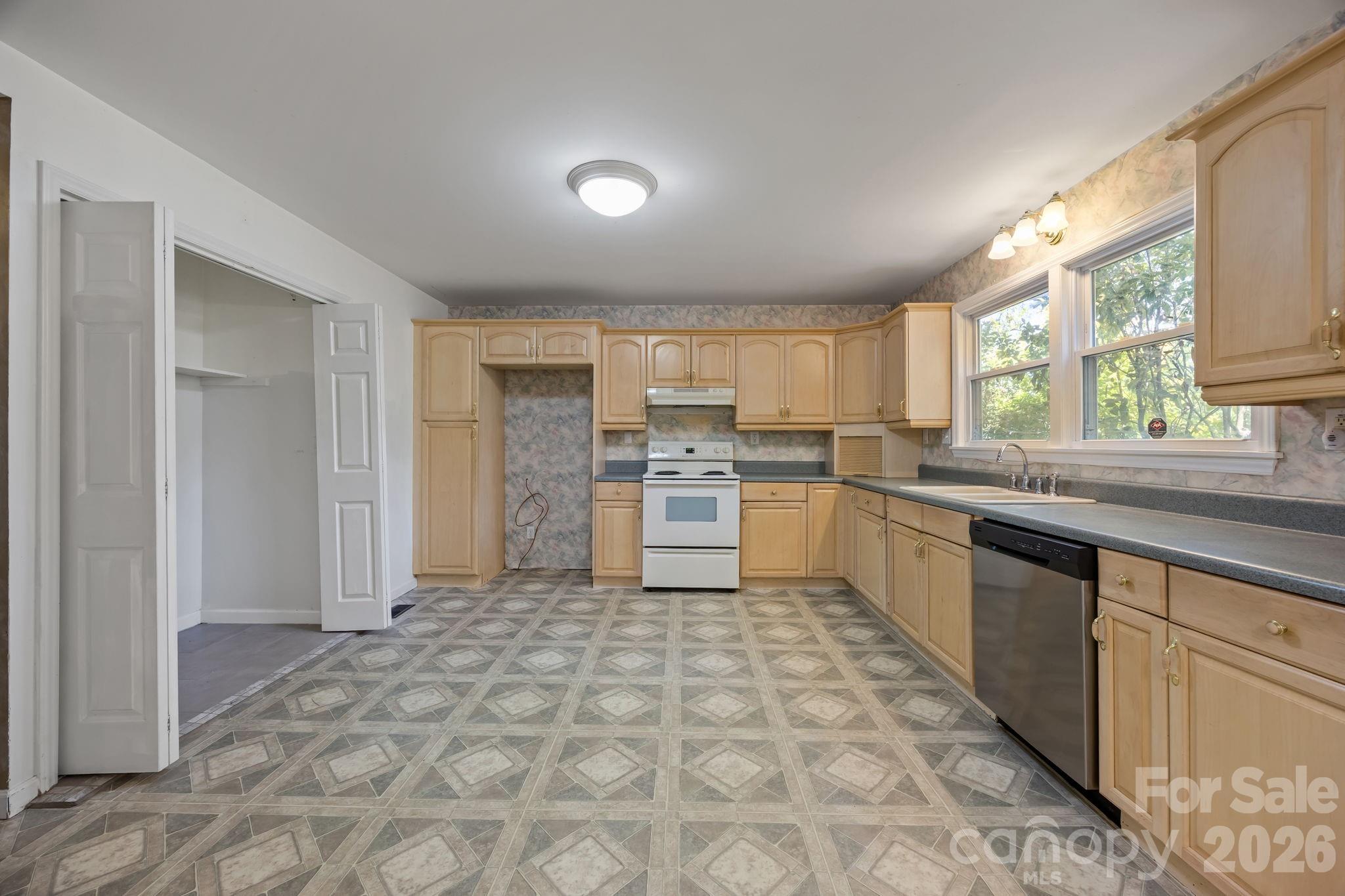 1311 Jenkins Road Gastonia, NC 28052 - Photo 23 of 47 a large kitchen with stainless steel appliances granite countertop a sink and cabinets