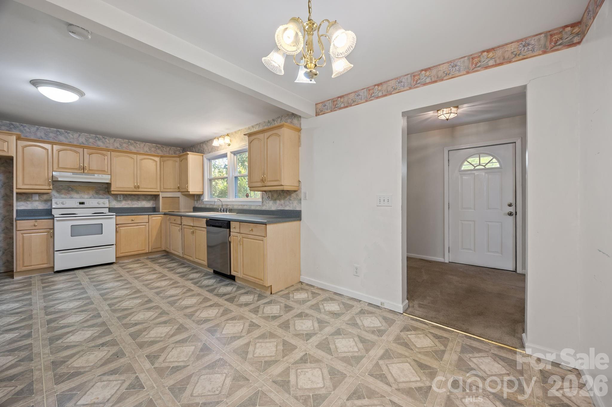 1311 Jenkins Road Gastonia, NC 28052 - Photo 25 of 47 a kitchen with a refrigerator a sink dishwasher a stove and a refrigerator with wooden floor
