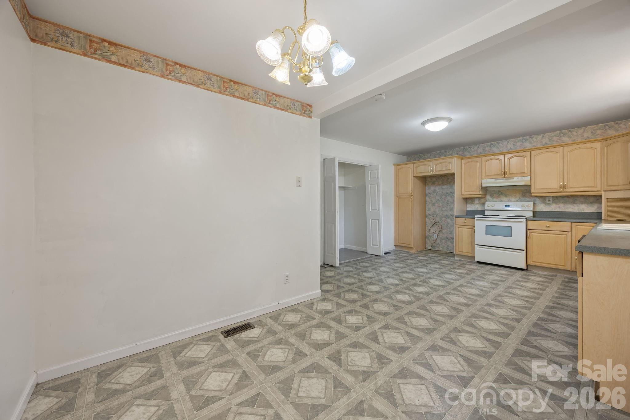 1311 Jenkins Road Gastonia, NC 28052 - Photo 26 of 47 a view of a kitchen with a microwave and a stove