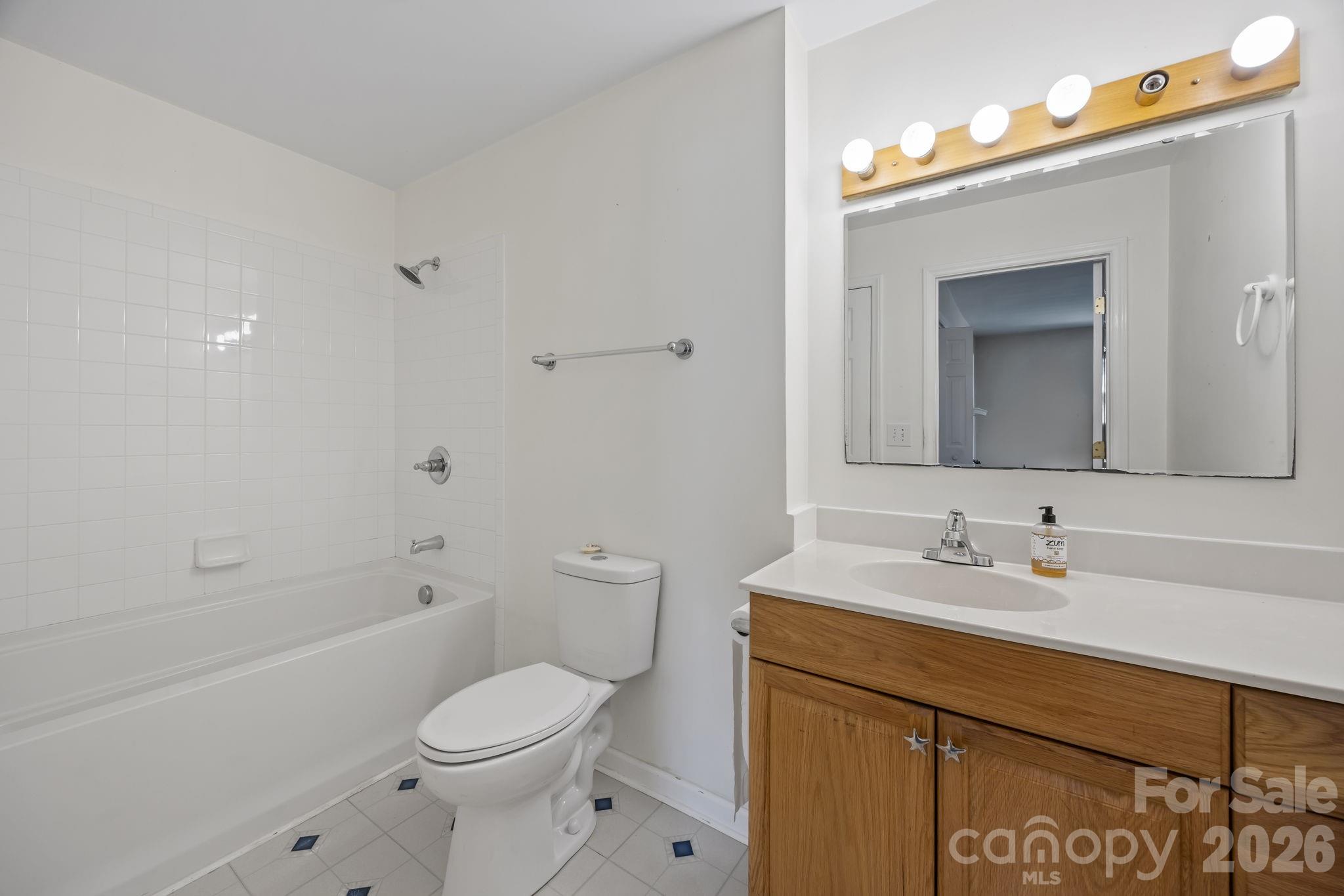 1311 Jenkins Road Gastonia, NC 28052 - Photo 29 of 47 a bathroom with a sink toilet vanity and shower