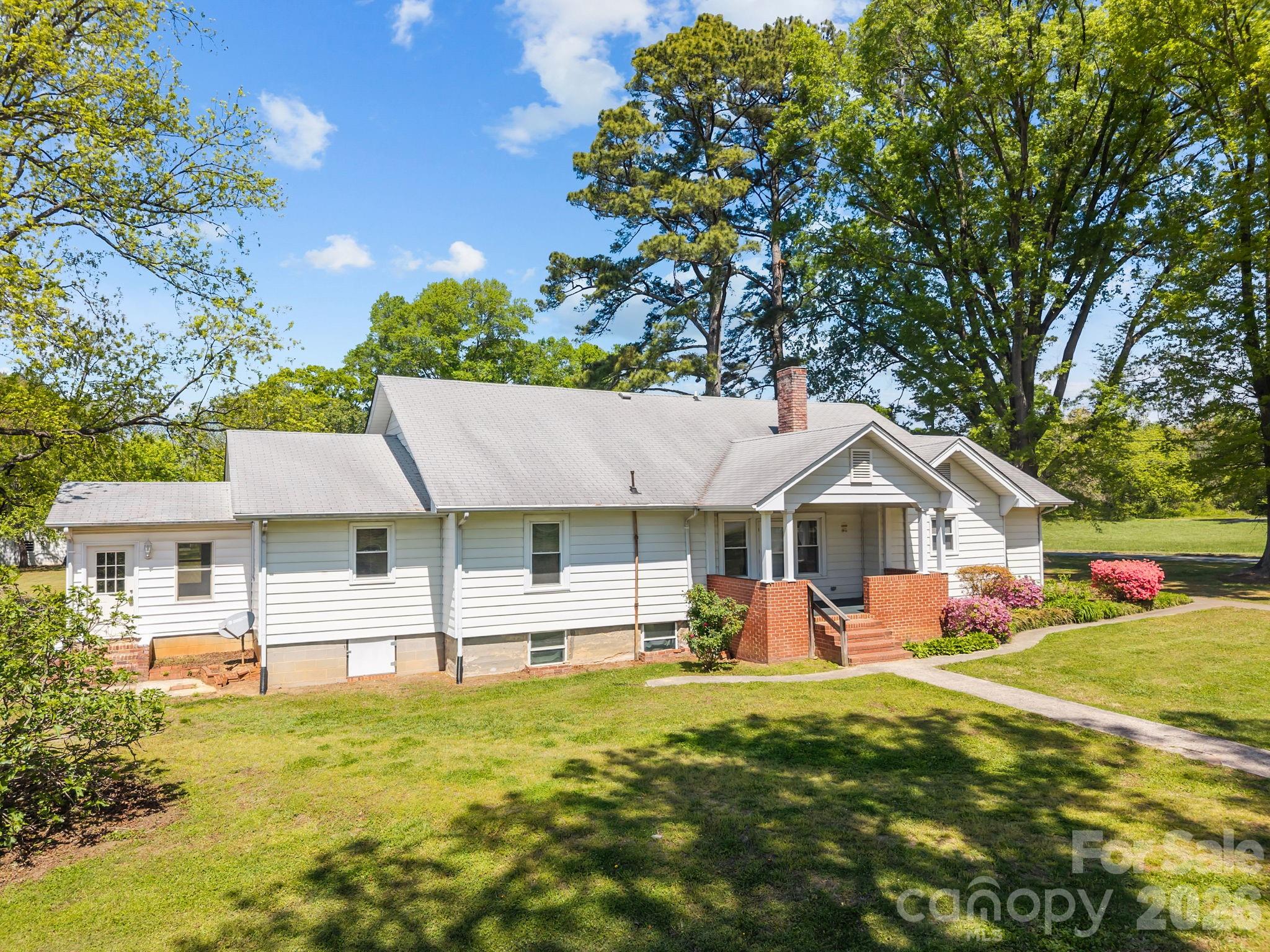 1311 Jenkins Road Gastonia, NC 28052 - Photo 3 of 47 a front view of a house with a yard porch and furniture