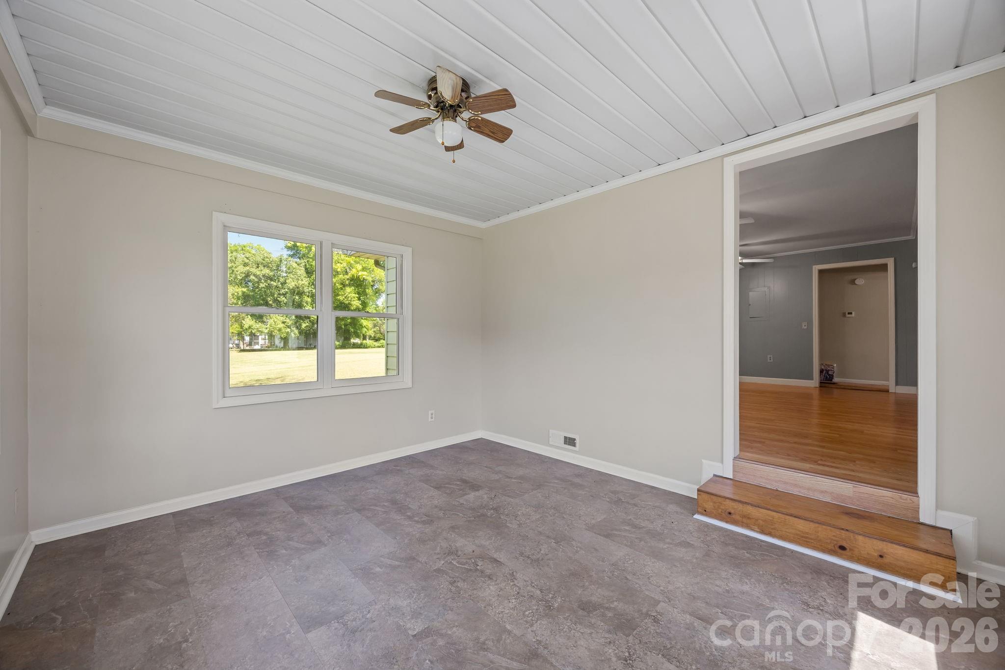1311 Jenkins Road Gastonia, NC 28052 - Photo 31 of 47 en empty room with windows and ceiling fan