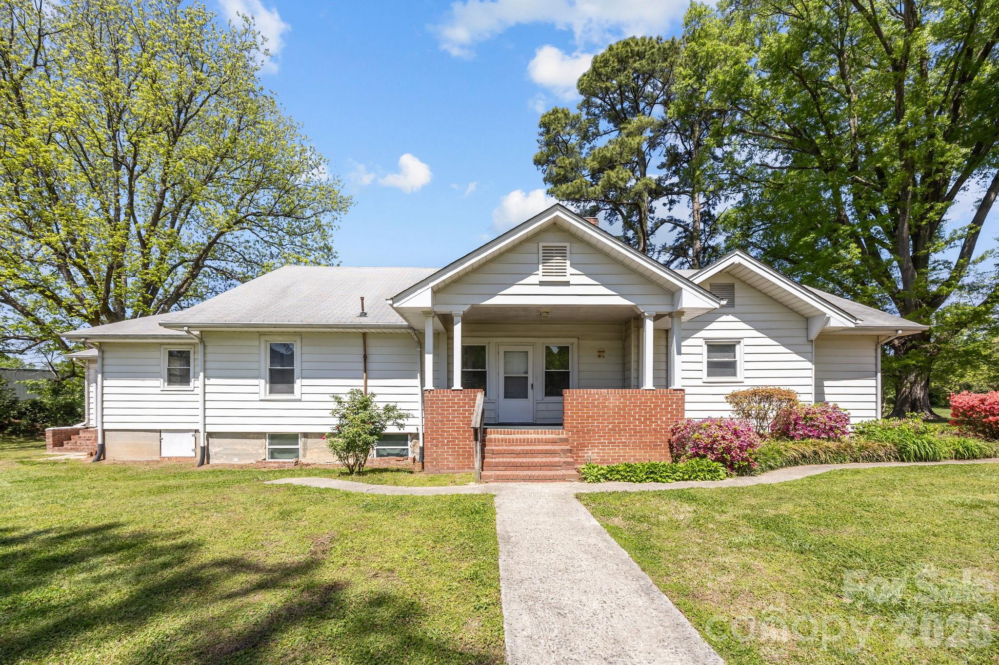 1311 Jenkins Road Gastonia, NC 28052 - Photo 41 of 47 a front view of a house with garden