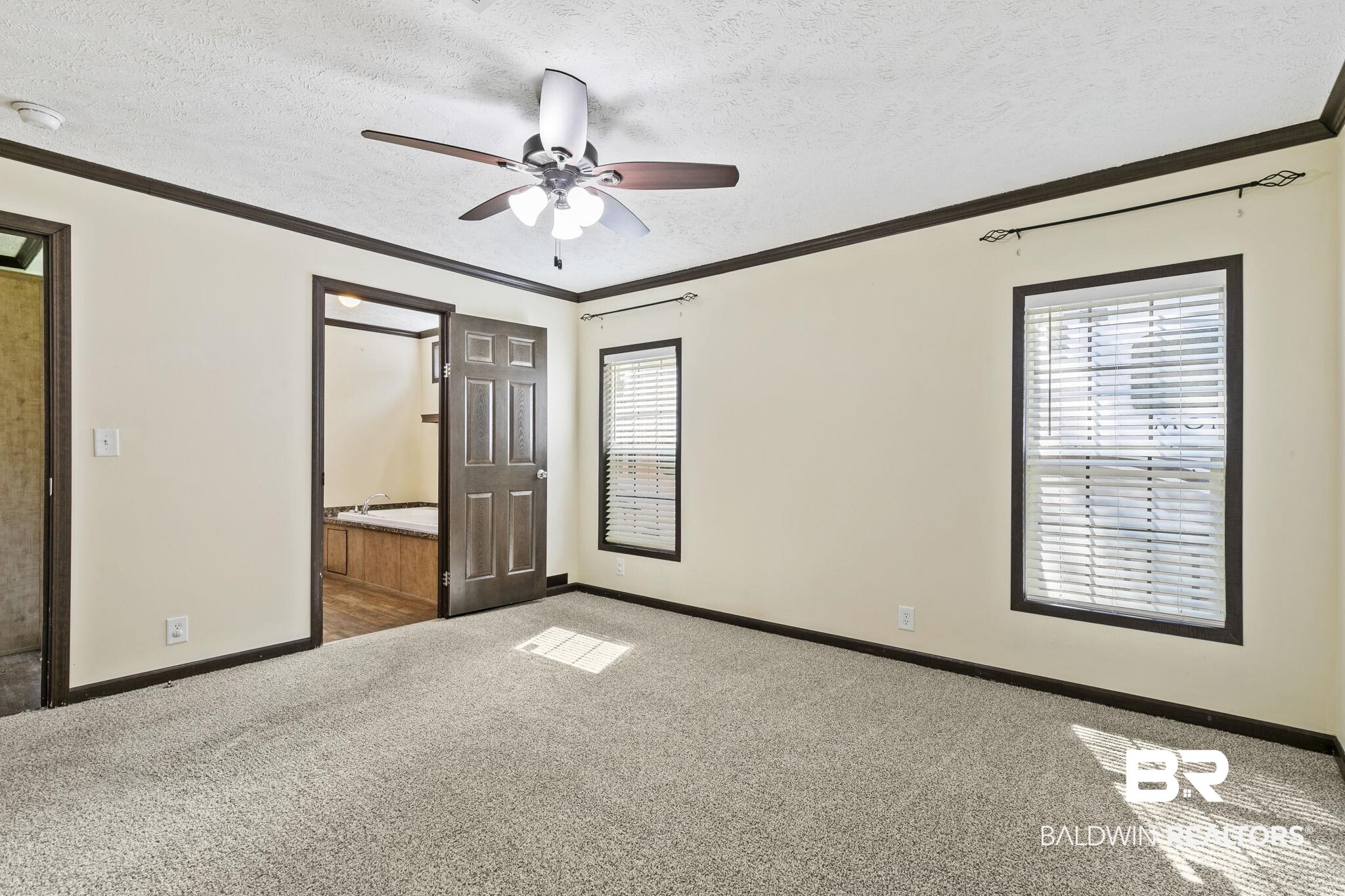 35641 County Road 39 Stapleton, AL 36578 - Photo 31 of 46 Unfurnished bedroom with a textured ceiling, light carpet, ceiling fan, and ensuite bath