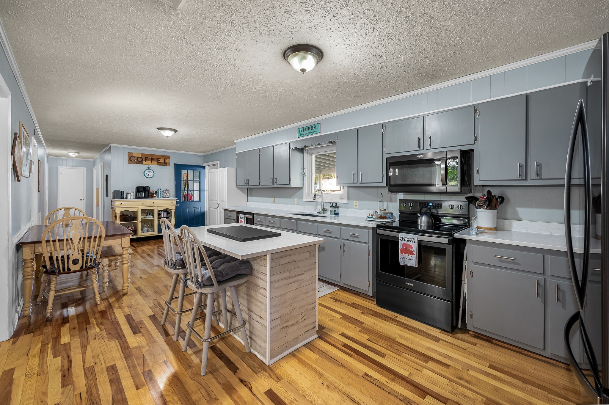 109 Higgins Road Woodbury, TN 37190 - Photo 12 of 49 The kitchen is well appointed with refinished hardwood floors, custom island and stainless appliances.