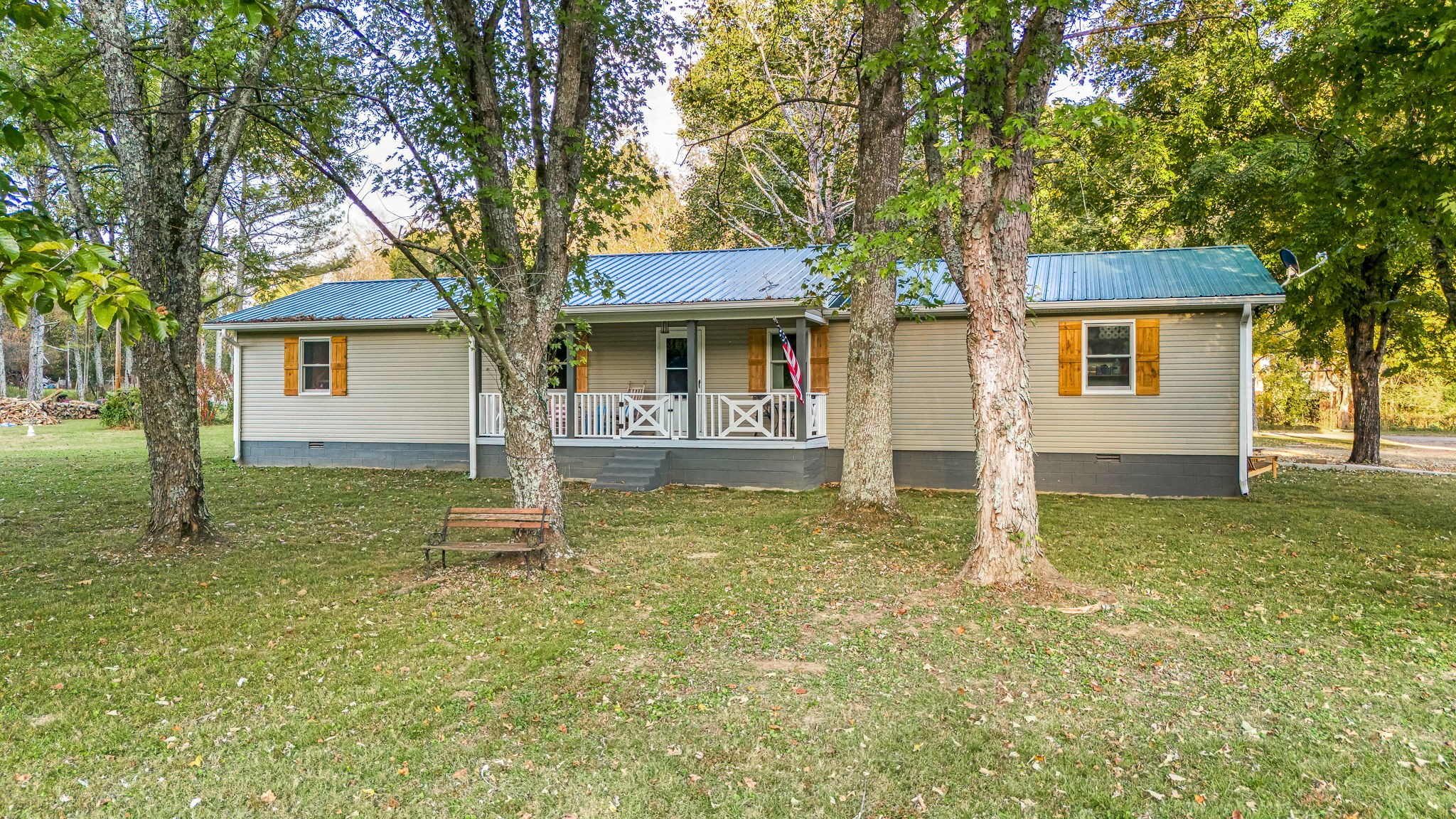 109 Higgins Road Woodbury, TN 37190 - Photo 3 of 49 Metal roof, covered front porch, custom wood shutters, mature trees and a level lot... just to name a few.