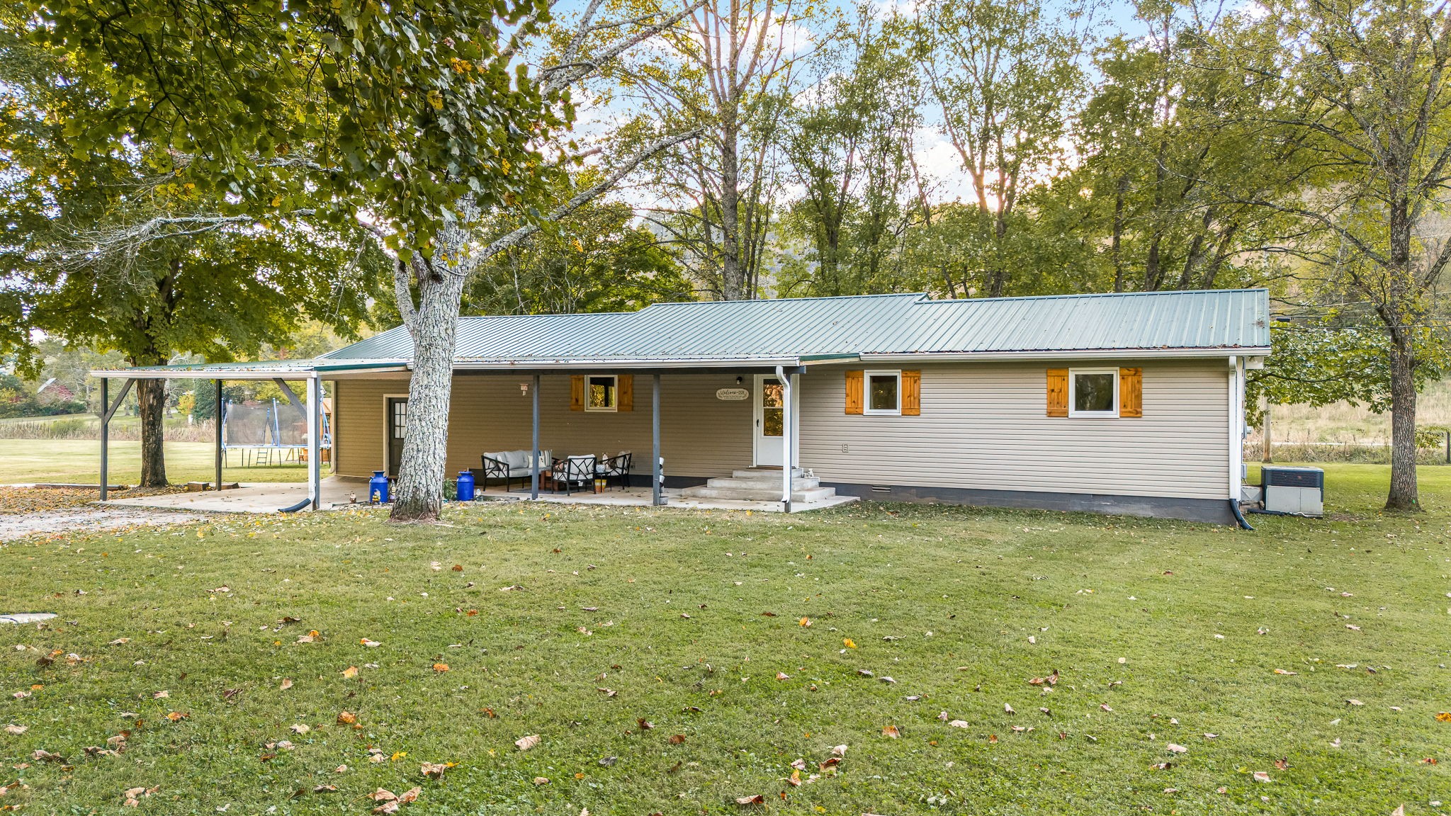 109 Higgins Road Woodbury, TN 37190 - Photo 6 of 49 2 car covered carport, 12x27 covered back patio and new Renewal by Andersen windows.
