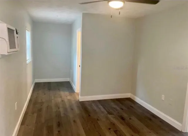a view of a room with wooden floor