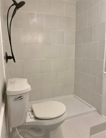 a bathroom with a toilet and a shower