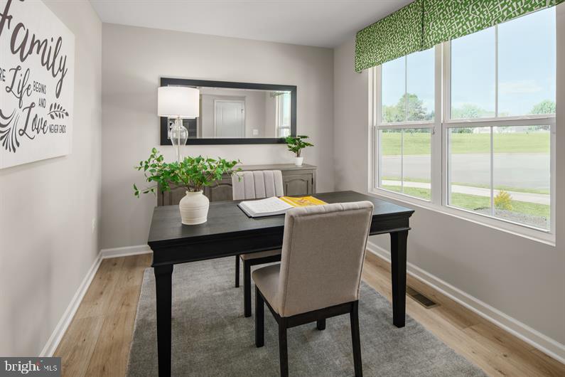 9205 Cooks Point Court, Unit 29 Lanham, MD 20706 - Photo 6 of 14 a view of a dining room with a table and chairs