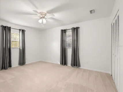 a bathroom with a granite countertop sink a toilet and a mirror
