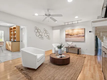 a living room with furniture a fireplace and potted plants