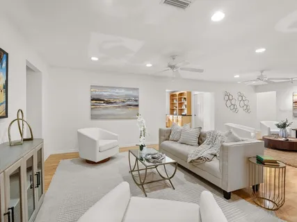 a view of a dining room with furniture and chandelier