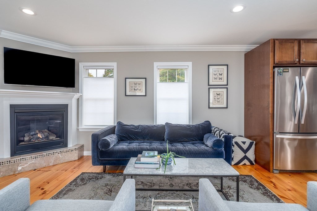 8 Collette Road Sturbridge, MA 01518 - Photo 11 of 28 a living room with furniture a flat screen tv and a fireplace