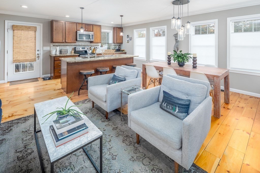 8 Collette Road Sturbridge, MA 01518 - Photo 12 of 28 a living room with furniture wooden floor and a kitchen view