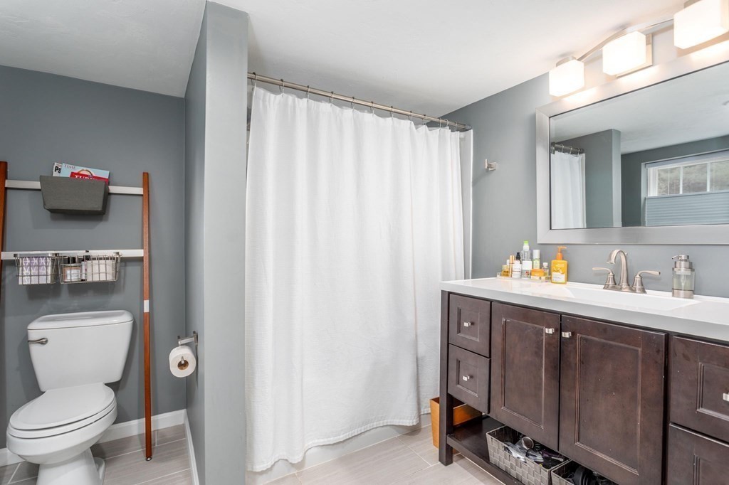 8 Collette Road Sturbridge, MA 01518 - Photo 17 of 28 a bathroom with a toilet a sink and a mirror