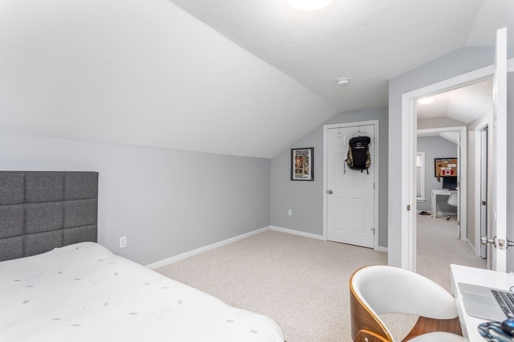 8 Collette Road Sturbridge, MA 01518 - Photo 19 of 28 a bedroom with a bed and glass chair
