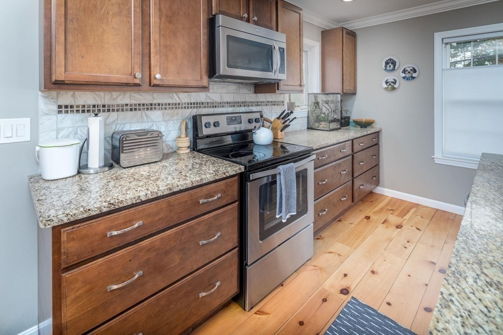 8 Collette Road Sturbridge, MA 01518 - Photo 7 of 28 a kitchen with stainless steel appliances granite countertop a sink stove and cabinets
