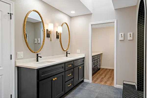 a bathroom with a double vanity sink and a mirror