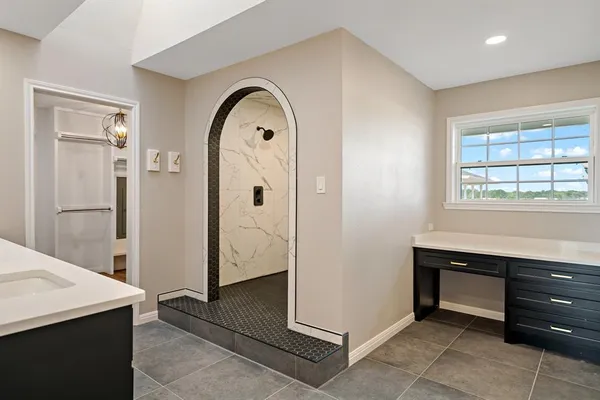 a view of room with window and hallway