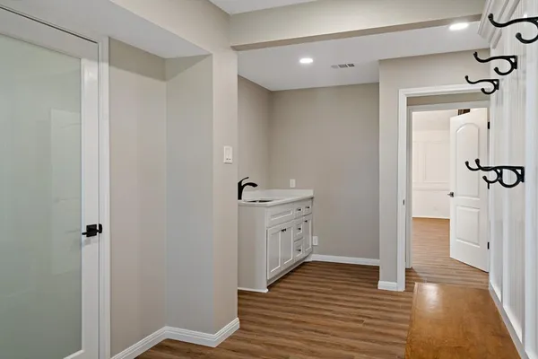a bathroom with a sink a toilet a glass door shower and a mirror