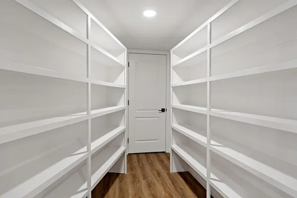 a view of walk in closet with empty racks
